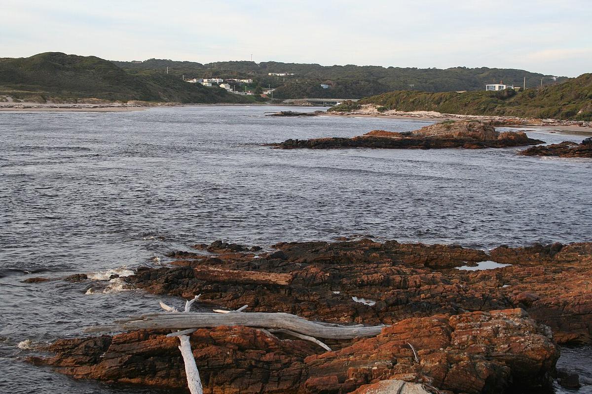 The mouth of the Arthur River in north west Tasmania, with the township and bridge behind