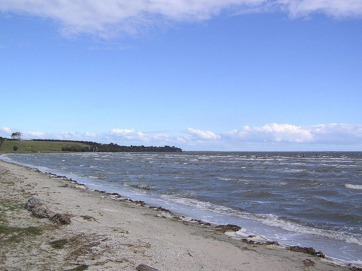 Wind-driven chop on Lake King in the Gippsland Lakes, seen from a sandy shore