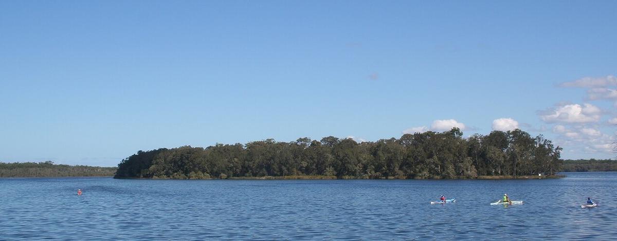 Kayakers on Myall Lakes seen from Violet Hill camping area, New South Wales