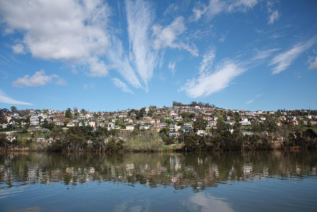 The Tamar River at Launceston, Tasmania, with hillside houses reflected in still water